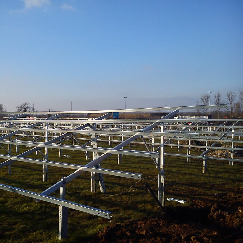 Ground-mounted solar panels being removed from mounting brackets on a solar farm