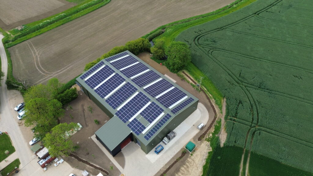 Aerial view of solar panels installed on a barn roof